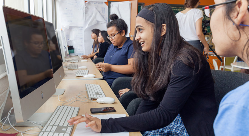 High school students at the Ann Richard School for Young Women Leaders work on an online assignment in their makers lab.