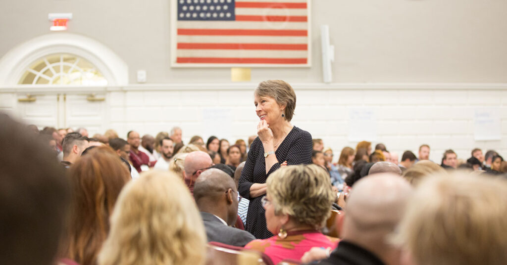 A professor at the Harvard Graduate School of Education address a lecture hall full of school principals