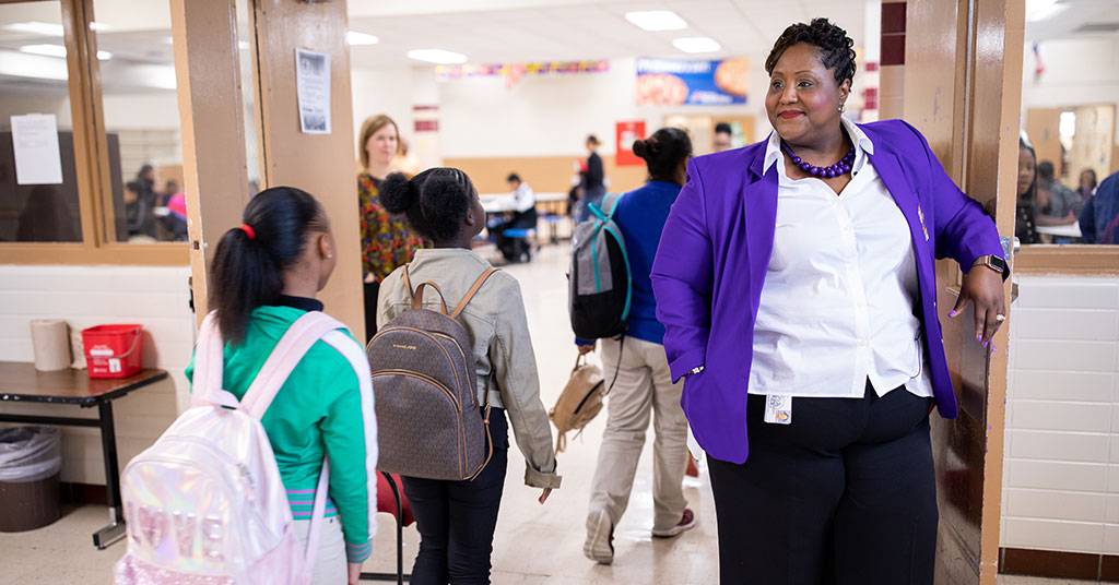 Erika Carter, principal of Key Middle School in Houston ISD, greets students as they enter the lunchroom.