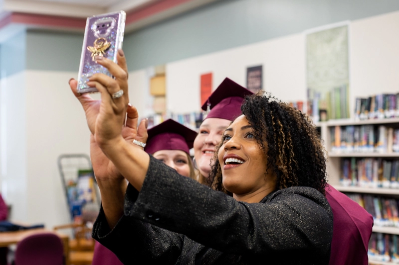 Principal Kimberly Darden takes a selfie with every graduate.