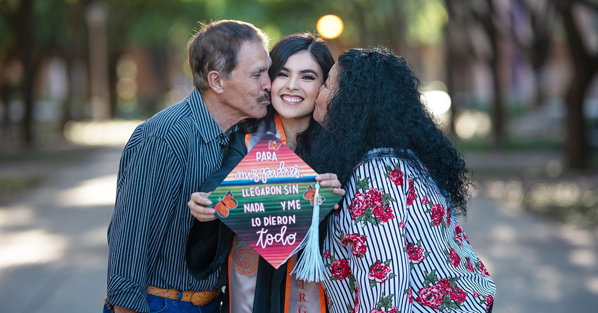 Raquel Perez and her parents pose for a graduation photo.