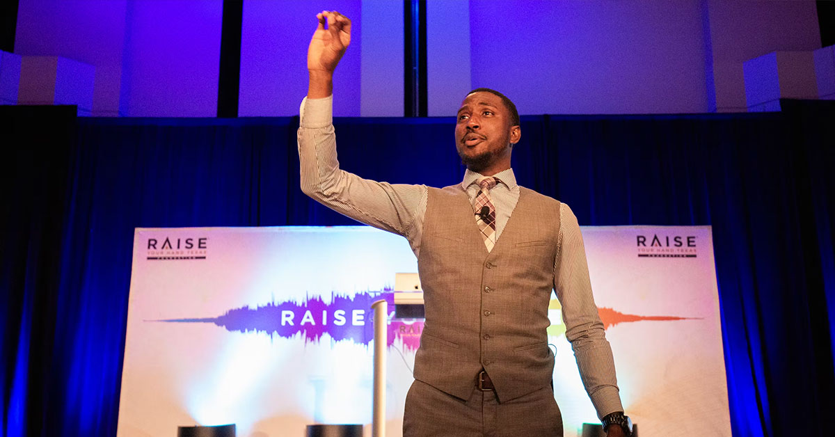 Michael Bonner gives a dynamic presentation on stage at the 2018 Scholar Symposium hosted by the Charles Butt Foundation (formerly the Raise Your Hand Texas Foundation)