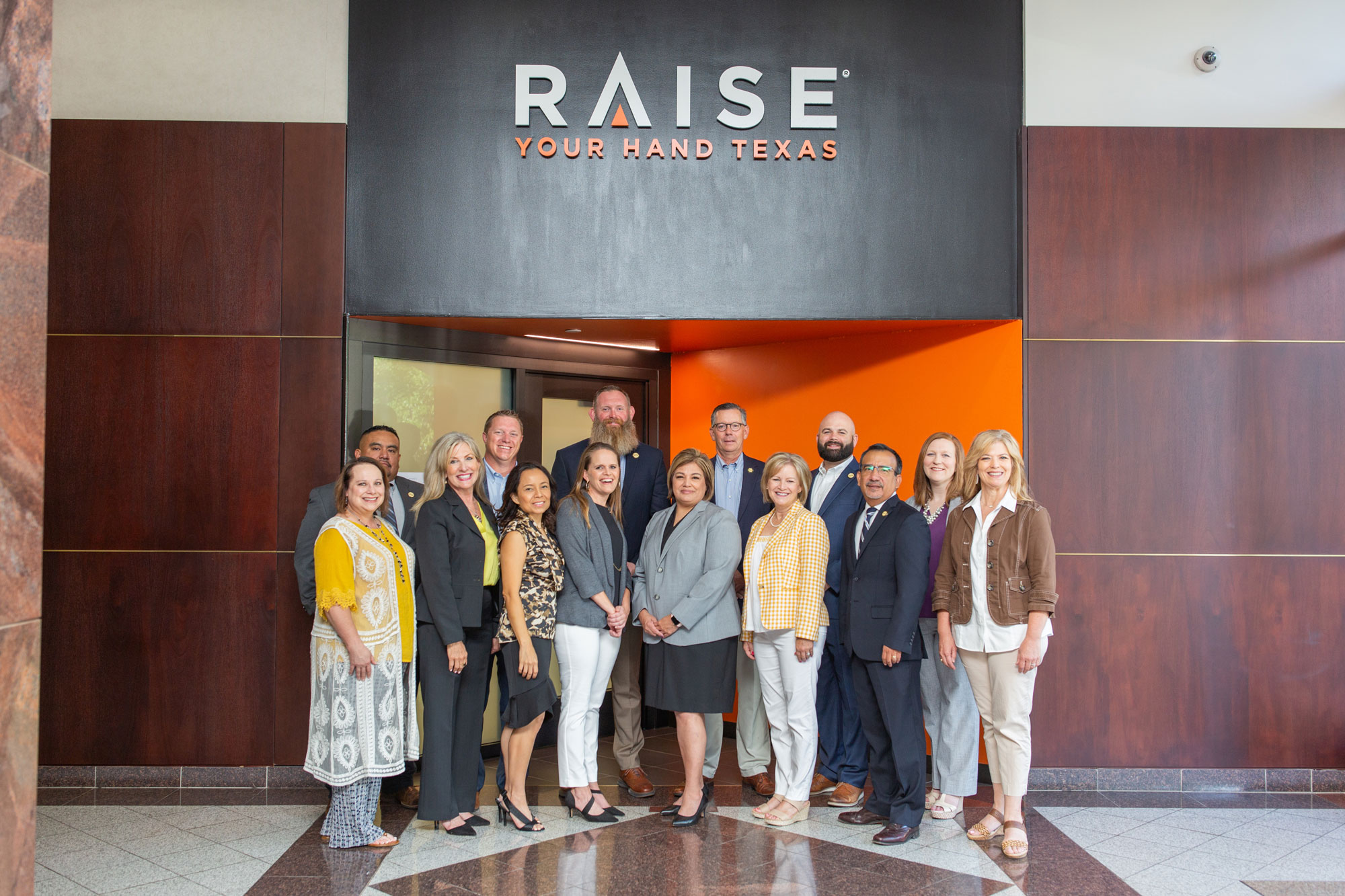 Regional Directors group shot outside of the old Raise Your Hand Texas entrance.