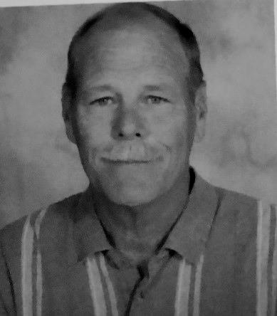 A black and white photo of "Coach Mac"