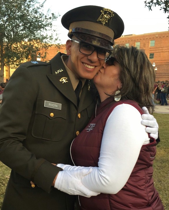 Marina Quilantan Rivera gives her son John Rivera, the 2016 valedictorian of LHS, a kiss on the cheek. He wears his Texas A&M Cadets uniform.
