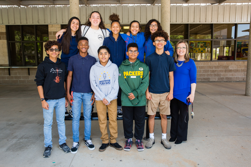 A group of student leaders pose for a photo with their principal, Valerie Torres-Solis.