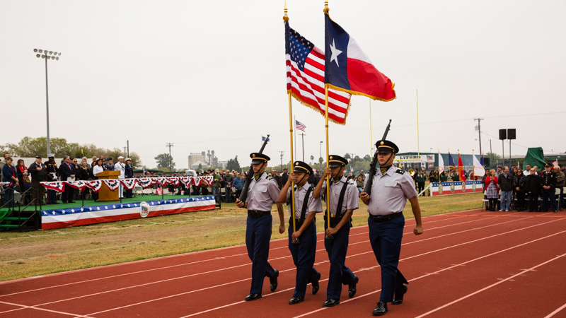 Members of the JROTC carry the American and Texas flag across the field at Lyford CISD's Veteran's Day ceremony.