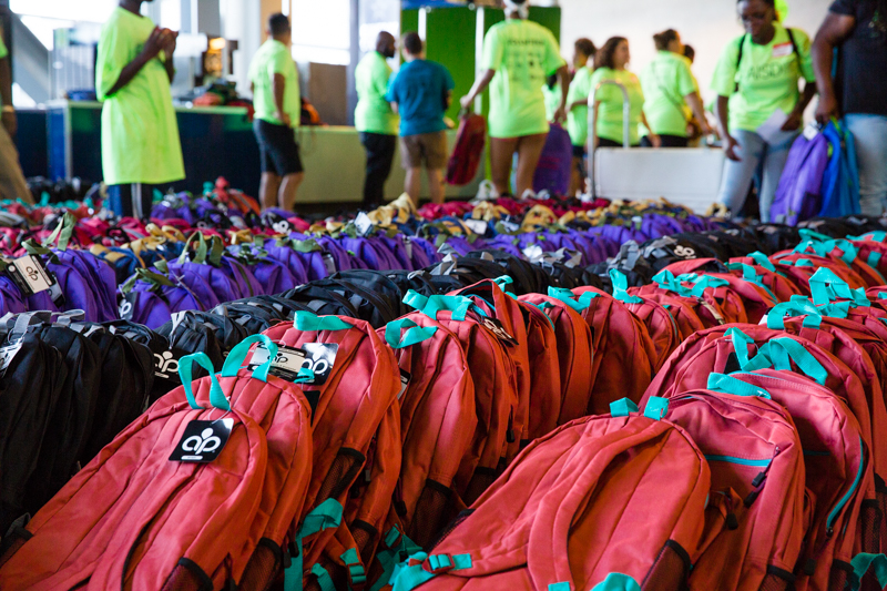 Back packs full of school supplies are passed out to families at the Arlington ISD back-to-school kickoff.