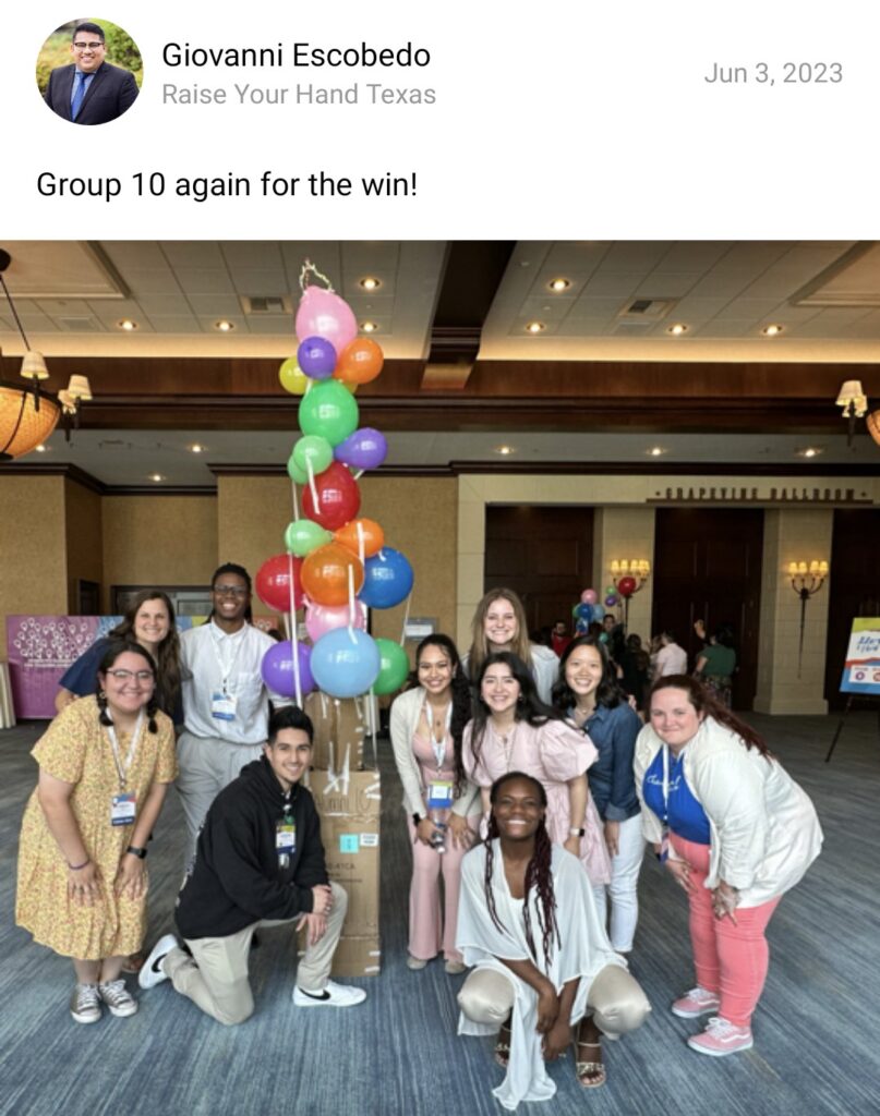 A group of 10 Charles Butt Scholar Alumni pose for a photo smiling in front of a balloon tower they built together during a team building exercise.