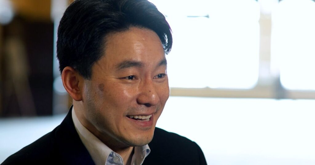 Junlei Li, the co-chair of the Human Development and Education Program at the Harvard Graduate School of Education, smiles for the camera during a sit down interview.