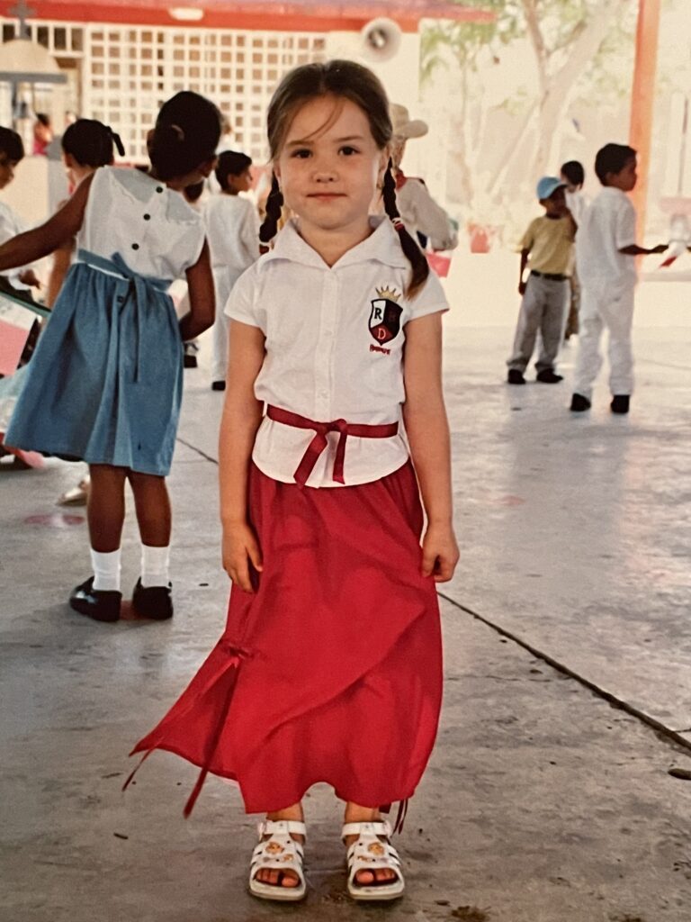 A childhood portrait of Carolina De Anda, whose early experiences navigating a new language and culture as a young immigrant inspired her dream to become an educator.